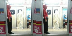 Woman carries out early morning prayer in train carriage