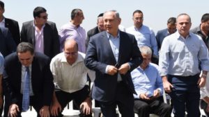 PM Benjamin Netanyahu poses for a group picture with his government at the weekly cabinet meeting, held in the Golan Heights.