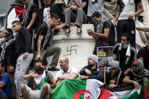 Protesters in support of Palestinians in Gaza display a swastika at a Paris rally.