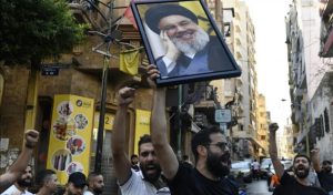 Protesters holding Hassan Nasrallah photo (photo: Anadolu Agency)