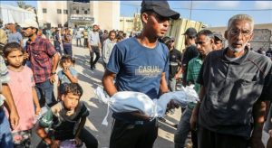 A man carries the starved body of 4-month-old Yahya al-Najjar who died of severe malnutrition as food crisis continues due to Israeli blockade, in Khan Yunis, Gaza on July 20, 2025 (photo: Anadolu Agency)